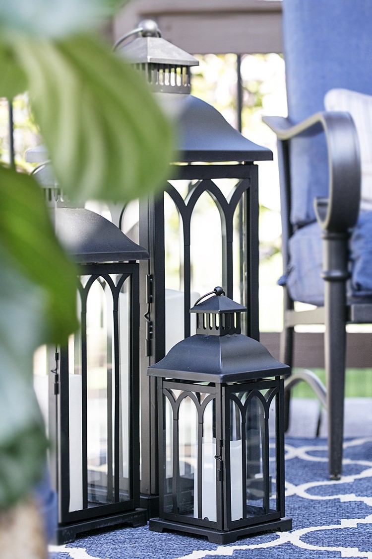 Black metal lanterns on a deck with a blue color scheme