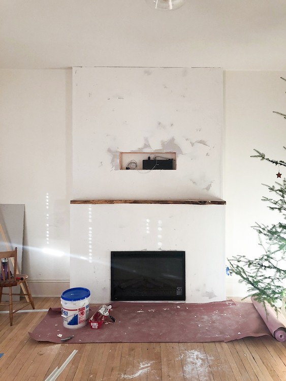 Jenni Radosevich of I SPY DIY transforms her living room into a warm and inviting space by adding a minimalist electric fireplace.