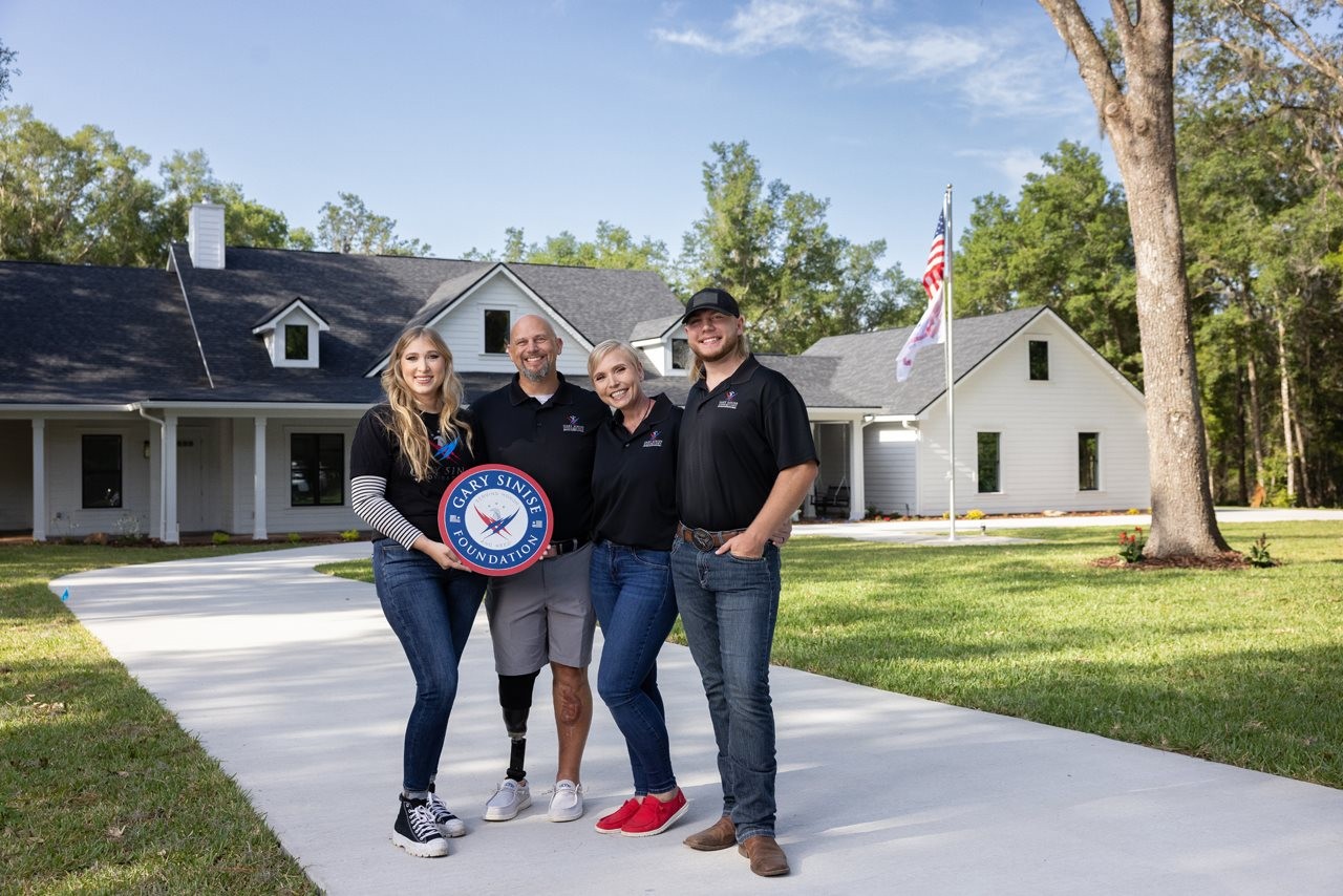 The Boarders family in front of their home.