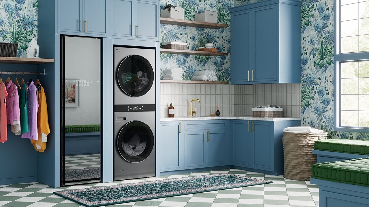LG Styler next to stacked washer and dryer in a laundry room