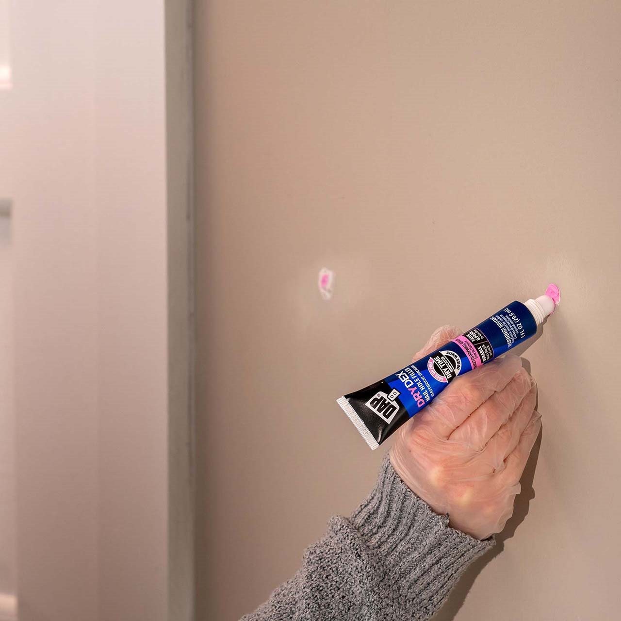 Man using Dry Dex Spackling on a wall