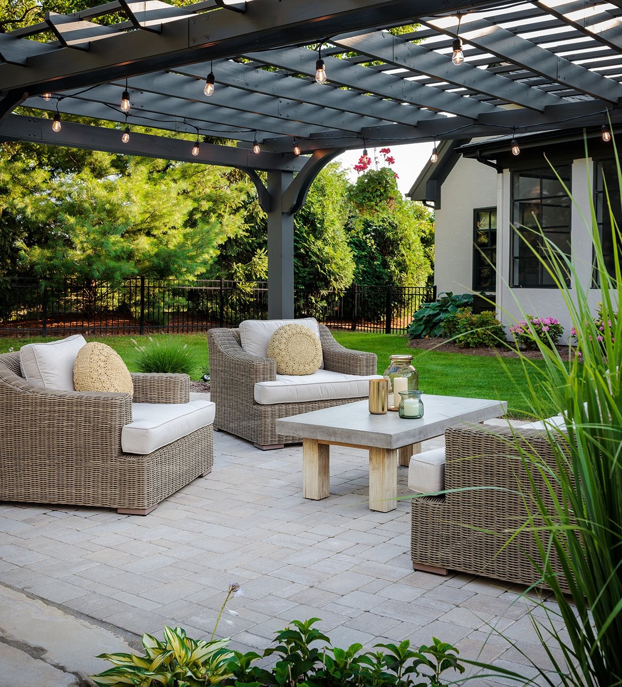 Private backyard with patio pergela and comfortable outdoor furniture.