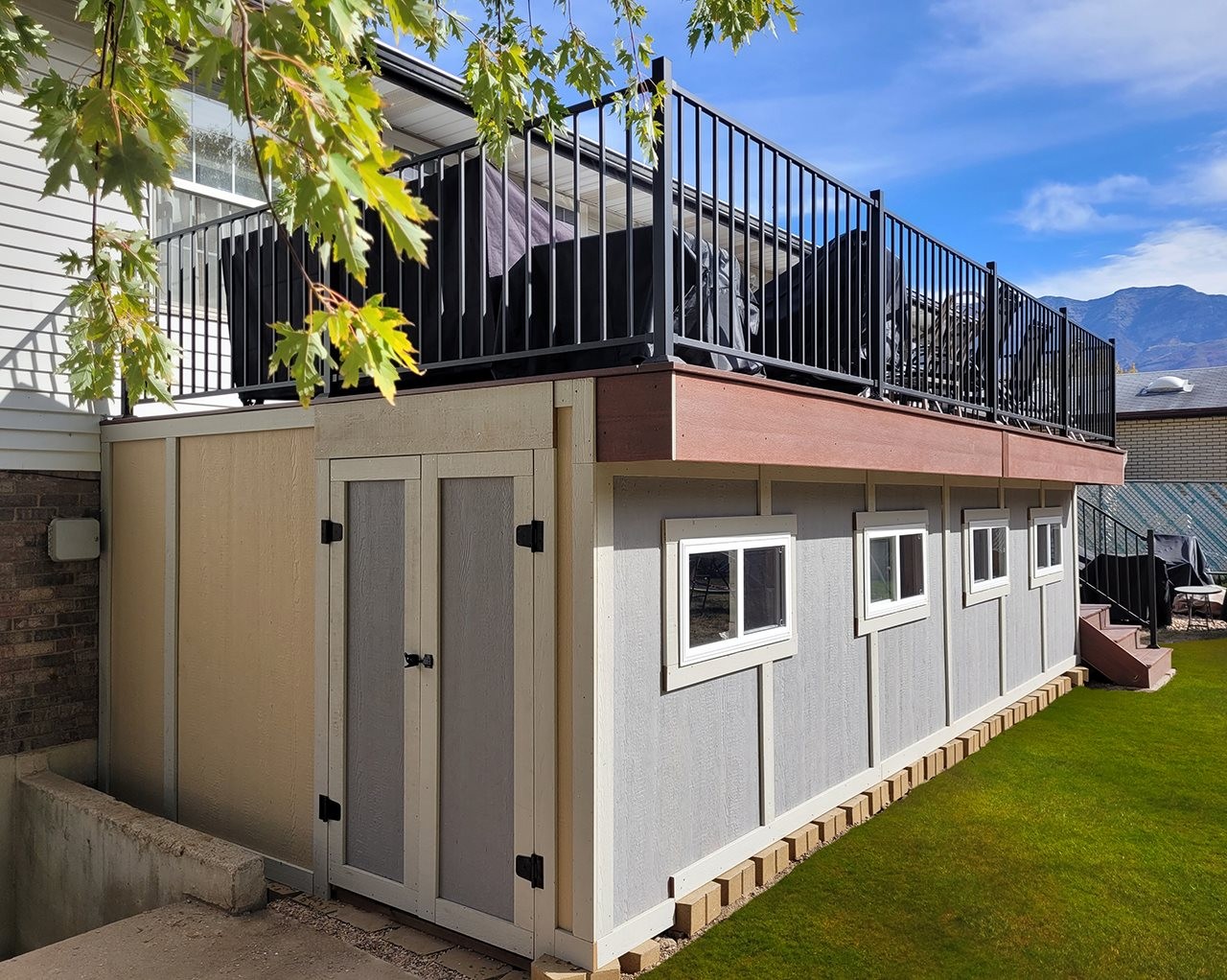 Second floor deck with a main floor storage shed