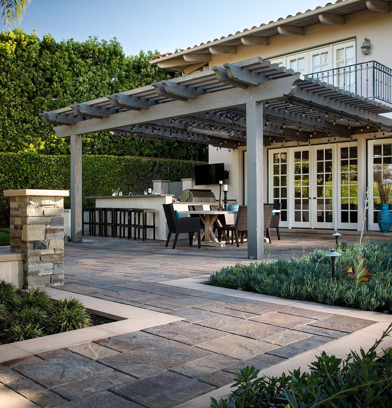 Huge patio with pegela with outdoor kitchen and dining area.