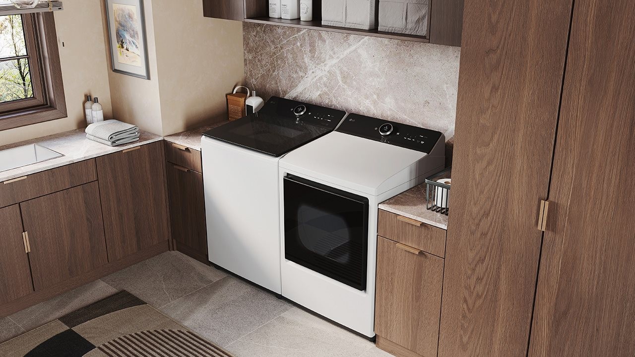 LG top  load washer and dryer in laundry room.
