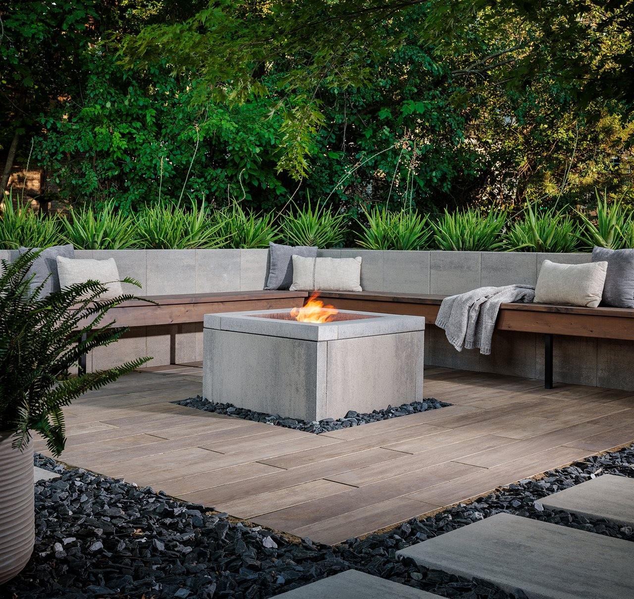 Backyard with landscaped patio and built-in seating and fire feature.