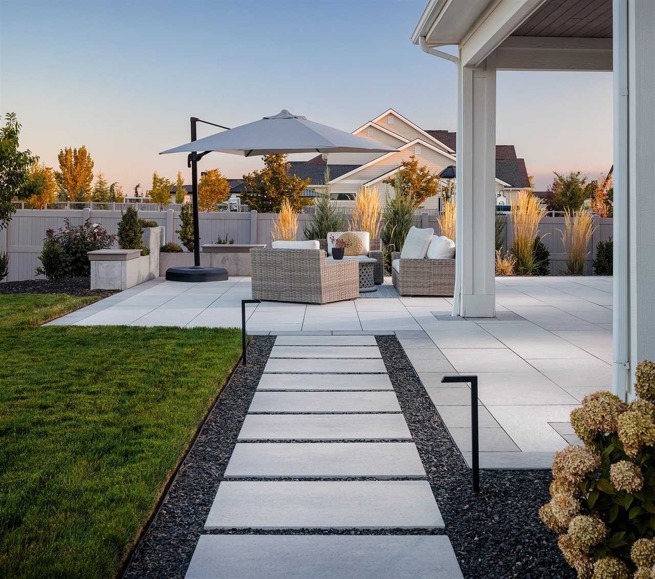 Belgard dimension slab pathway leading to an firepit and outdoor living area with comfortable furniture.