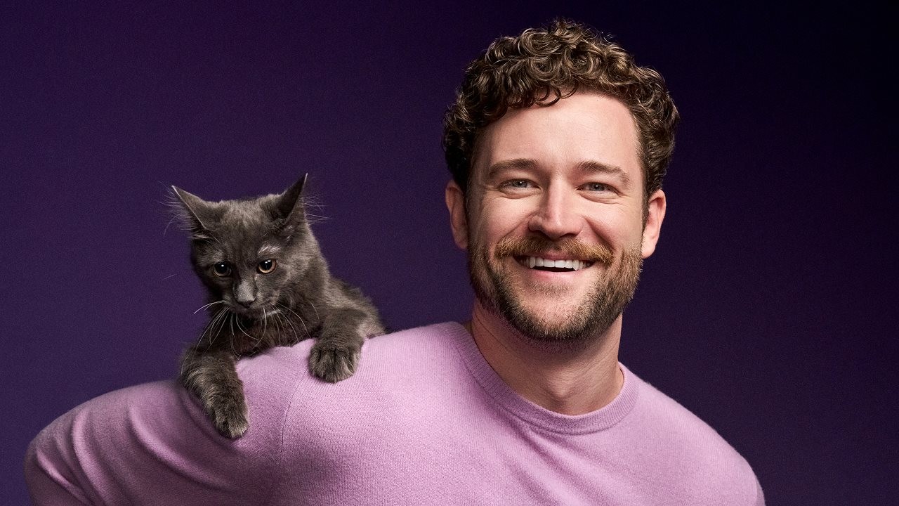 Cat dad with cat on to his shoulder.