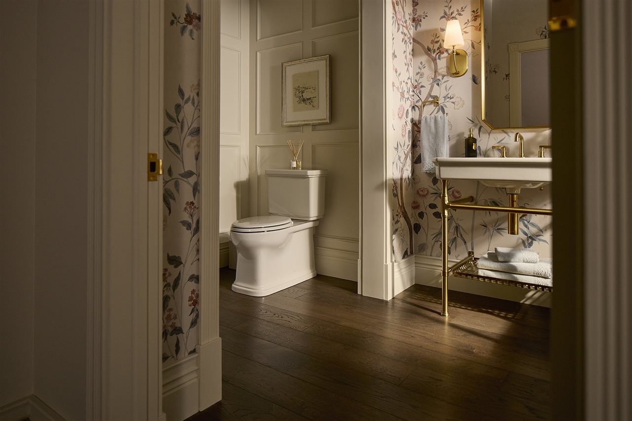 A sink with golden accents in an ornate bathroom.